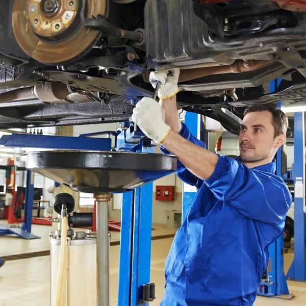 Automotive technician working on a car engine